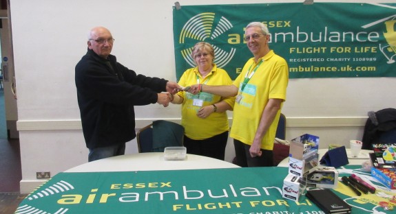 Dave G4UVJ presenting the raffle fund to Carole and Clive from Essex Air Ambulance