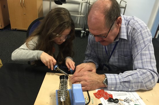 Essex Ham's youngest member learning how to solder with SOSLUG