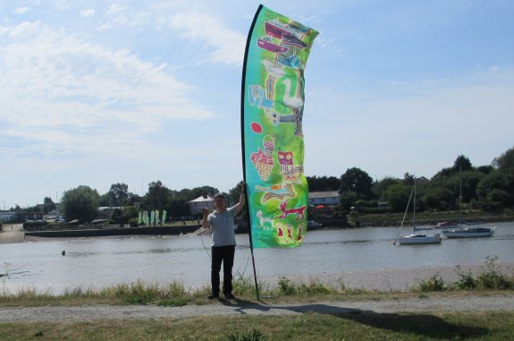 Pete M0PSX waving to the flag-bearers on the south bank of the Crouch