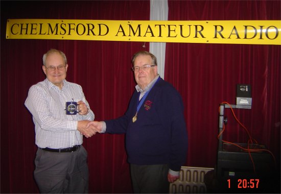 Dr Bopb Whelan getting his CARS mug from president Carl Thomson